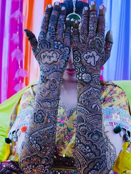 The beautiful mehndi for bride Saba, captured from different angles. The design includes personalized initials and a rich, dark stain.