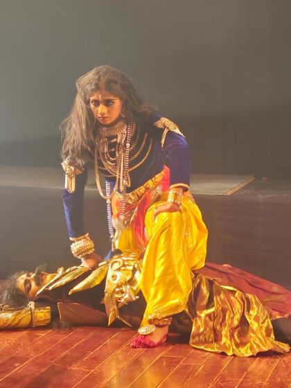 A powerful depiction of Krishna's victory over the tyrannical king Kamsa. The intense expressions and dramatic staging make this a climactic and memorable moment in the production.