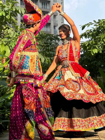 A classic dance pose that shows off both outfits beautifully. The way the colors and patterns work together is what makes my couple sets so popular.