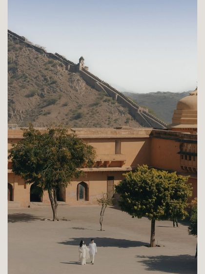 A wide shot capturing Vedika and Yuvraj against the grand scale of Amer Fort in Jaipur. This showcases how we use historical architecture to create epic and romantic pre-wedding imagery.