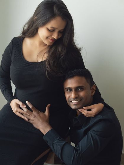 A sweet moment of connection with the baby. The dad-to-be listens closely to the bump, sharing a quiet moment with his partner and their little one on the way.