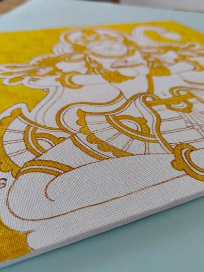 The Anjeneyar/Hanuman painting in its early stages, with a yellow base coat.