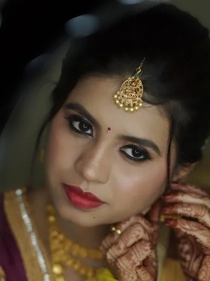 An artistic shot capturing the bride's stunning eye makeup and traditional nose ring.