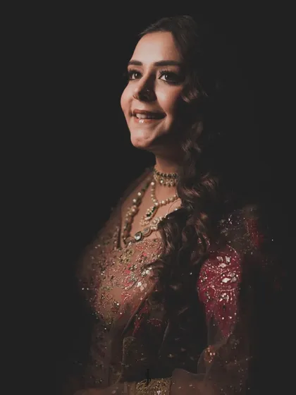 A portrait of a bride, glowing with happiness. This shot captures the essence of what we aim for: a look so perfectly you, it feels like a second skin. The right outfit and styling bring out that inner confidence.