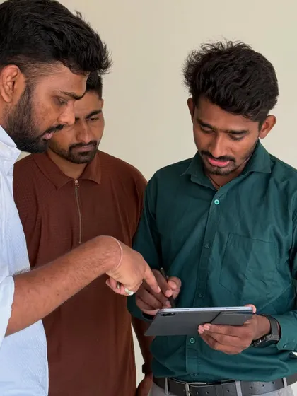A close-up of our team explaining the finer details of the design plan to the clients on a tablet.