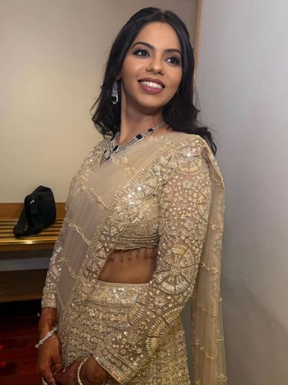 A candid, happy shot of the bride. The makeup enhances her smile and gives her a radiant, fairytale-like glow.