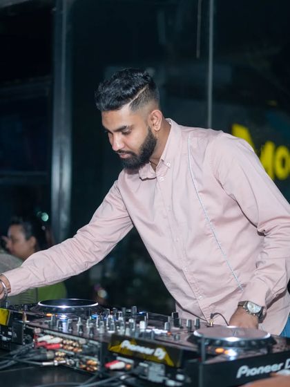 Adjusting the levels on my Pioneer mixer during a live set. My technical skill ensures a clean, powerful sound that defines the clubbing experience for the audience.