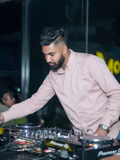 A side profile while I'm cueing up the next track. The flow of a DJ set is a journey, and every transition is carefully planned.