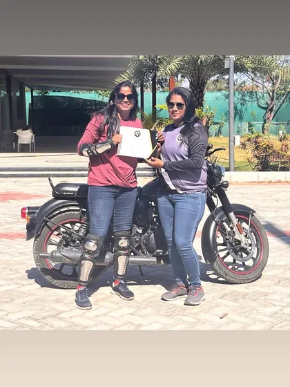A graduate and her coach celebrating her success. This photo captures the pride and partnership that defines our training program.