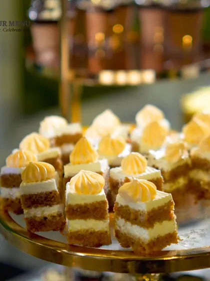 Bite-sized portions of layered pastry cake, perfect for guests who want to sample a variety of sweets.