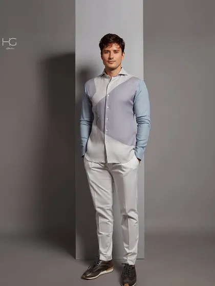 A full-length shot of the color-blocked shirt, paired with clean white trousers. It's a perfect look for a stylish daytime event or a casual evening out.