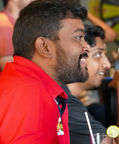 A fan's focused expression says it all. The tension and excitement of a live race are best experienced with a crowd.