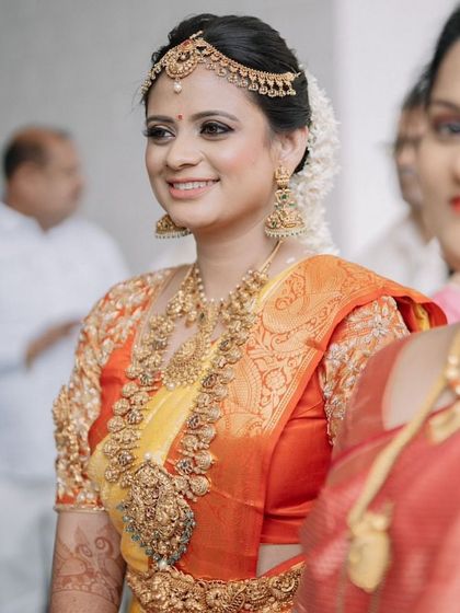 A happy bride is the most beautiful bride. Her genuine smile truly completes this classic South Indian wedding look, making her shine even brighter.