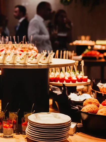 Another perspective of a bustling appetizer station. With stacked plates ready for guests, this image captures the abundance and variety we bring to every event.