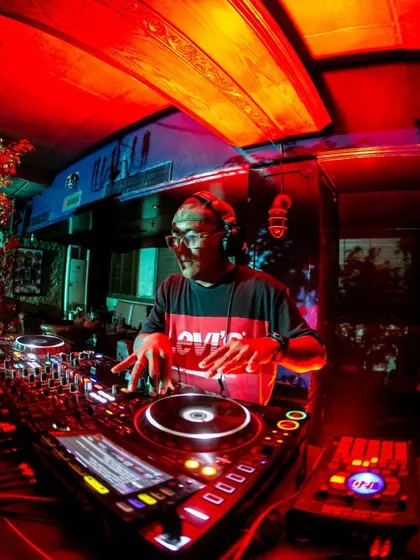 In my element, spinning tracks at Summer House Cafe. I bring that raw energy and deep knowledge of hip hop and R&B to every set, making sure the dance floor is always live.