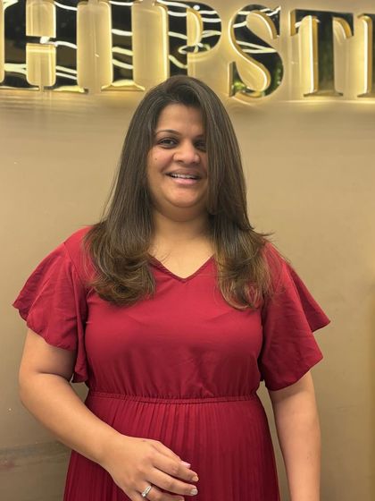 A happy client with her new global color. The uniform shade gives her hair a healthy, vibrant look that is both classic and stylish.