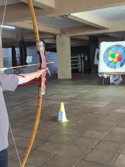 A young archer takes aim with an Indian Round Bow. I focus on teaching the correct draw and anchor technique, which is crucial for consistent shooting.