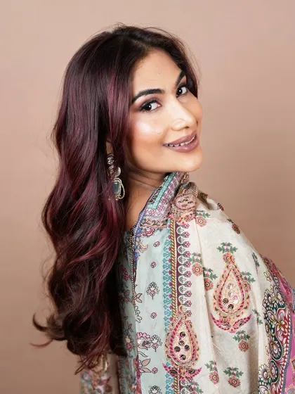 A smiling portrait that captures the shine and richness of the red hair colour. Our expert colour application ensures the hair looks healthy and vibrant.