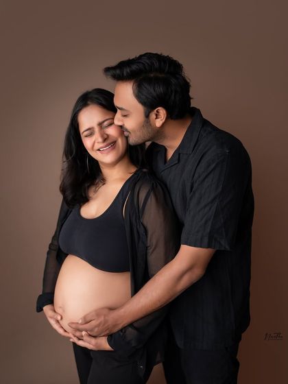 A candid, joyful moment from a couple's maternity shoot. I love capturing the laughter and happiness.