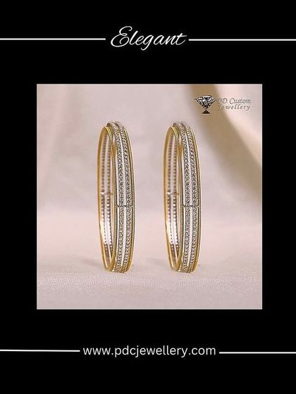 An elegant pair of running diamond bangles in 14kt hallmarked gold. The design features three fine lines, with the central one studded with diamonds.