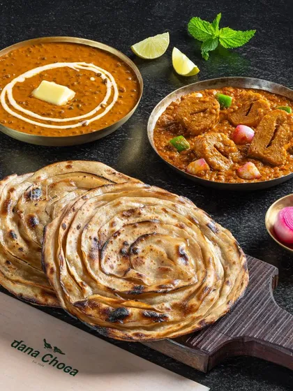 A vegetarian combo of Dal Makhani and Soya Chaap Masala with lachha parathas for Dana Choga.