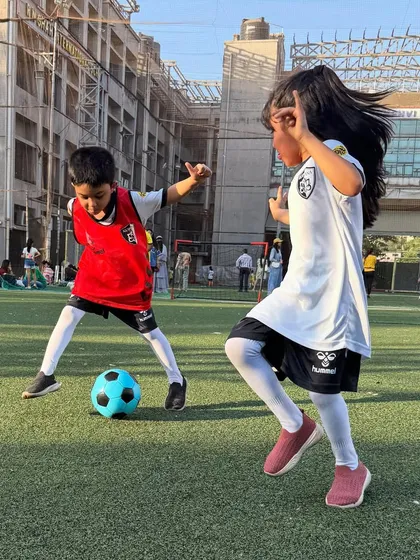 A moment of pure joy and playful competition on the pitch. Our sessions for young girls and boys encourage active play and healthy interaction in a supervised setting.
