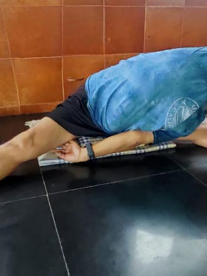 A deep forward bend in Samakonasana (Side Splits), showing the full range of motion in the hips.