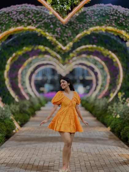 A joyful shot in the Miracle Garden. The puff sleeves and A-line cut of this dress make it a fun and flattering choice.