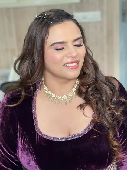 A happy, smiling shot of the groom's sister. The makeup is fresh and pretty, perfect for a day of celebrations.