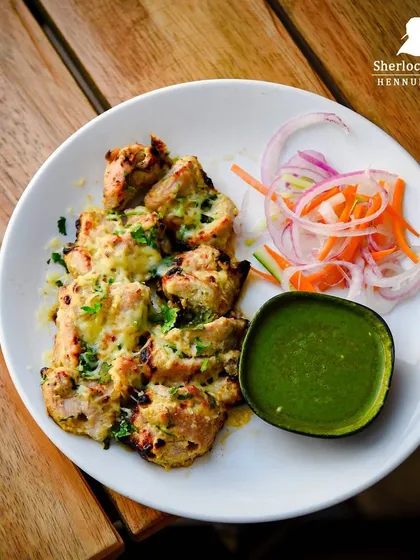 Our Cheesy Chicken Malai Tikka is pure indulgence. Tender chicken pieces are marinated in a creamy sauce, grilled, and topped with cheese.