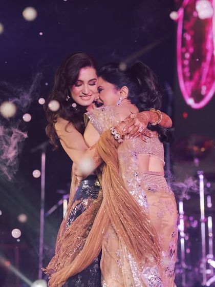 A touching, candid hug between sisters on stage after a performance. These are the real, emotional moments that make our work so rewarding.