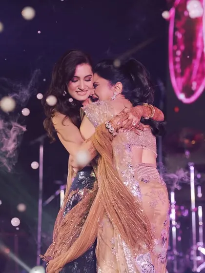 A touching, candid hug between sisters on stage after a performance. These are the real, emotional moments that make our work so rewarding.