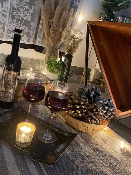 Another view of the rustic wine and candle arrangement, showing the warm and inviting textures of the decor.