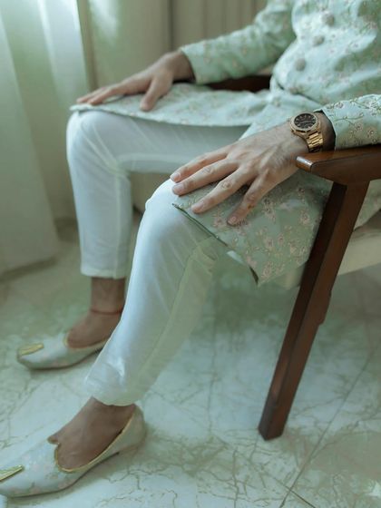 A detail shot of the groom's hands and his elegant watch. This photo focuses on the small details that complete his wedding day look.