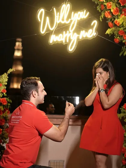 A perfect moment captured, where love says 'yes' against the timeless silhouette of the Qutub Minar. I help you craft proposals that are as unique and beautiful as your own love story.