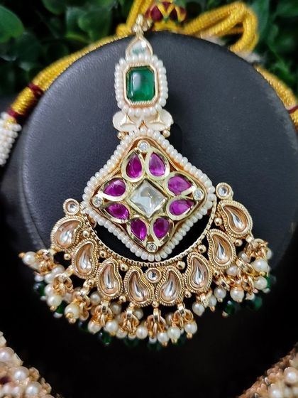 The maang tikka for this set, showcasing the same colorful stone combination.