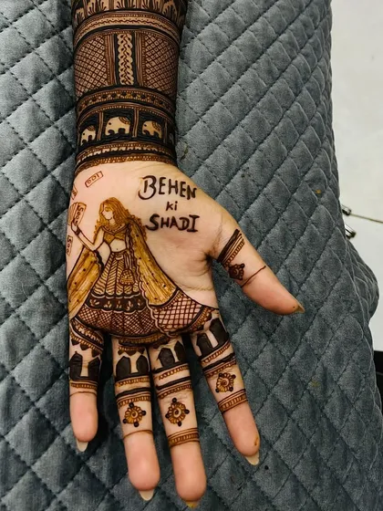 A close-up of the "Behen ki Shaadi" design. The portrait of the girl holding a phone is a fun, modern twist on traditional mehendi.