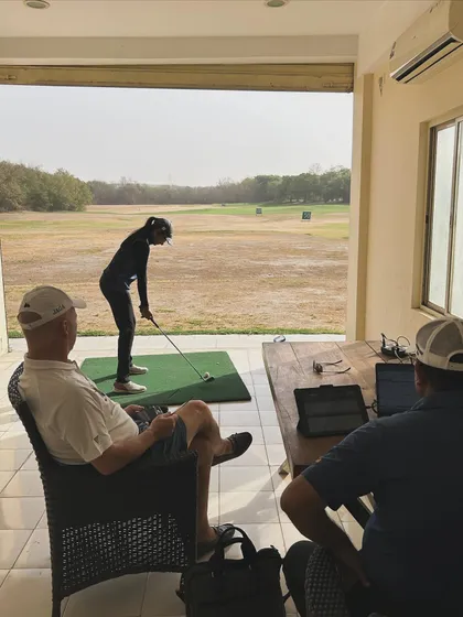 Analyzing a player's swing with other coaches during the camp. A collaborative approach benefits everyone.