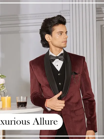 Luxurious allure. This deep maroon velvet tuxedo with a black shawl collar is the epitome of sophisticated taste. It's perfect for a cocktail evening or a winter wedding reception.