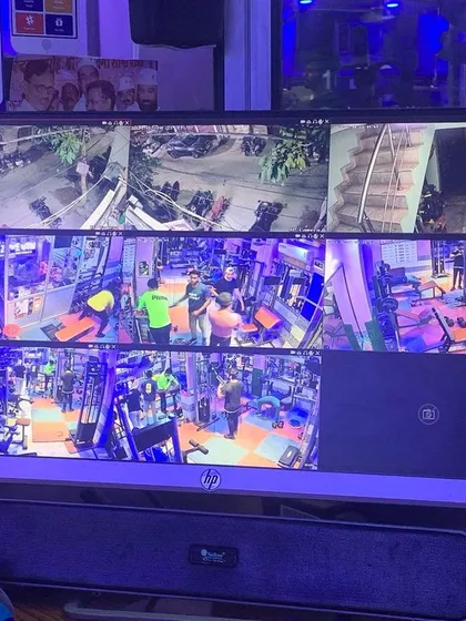 A closer view of the gym's security monitor, showing different workout zones and the entrance.