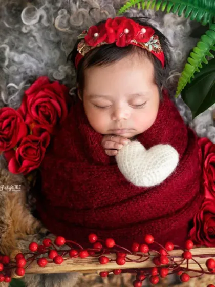 Holding a little white heart, this sleeping baby is the picture of innocence. I use small, simple props to enhance the story of the photograph without overwhelming the subject.