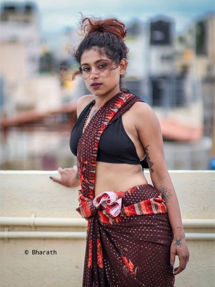 This portrait showcases a unique way of draping the saree, creating a bold and contemporary fashion statement.