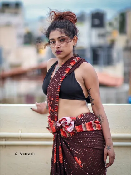 A full-body shot showing the unconventional drape of the saree, tied at the waist. This highlights a creative and modern approach to ethnic fashion.