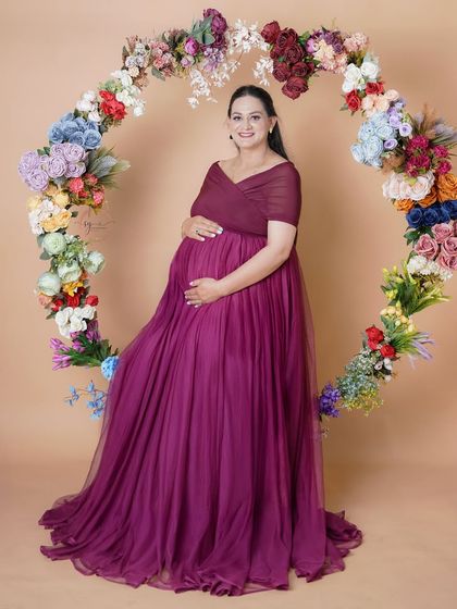 A full-length solo portrait framed by our colorful floral hoop. The rich purple gown and the vibrant flowers create a stunning visual contrast.