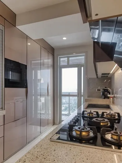 The cooking area of the JP Decks kitchen, featuring a modern hob and chimney with a rolling shutter for the microwave unit.