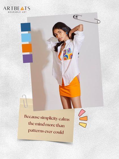 Because simplicity calms the mind. This oversized white shirt, paired with a bright orange skirt, shows how a single artful pocket can elevate an entire look. It’s about finding beauty in quiet details.