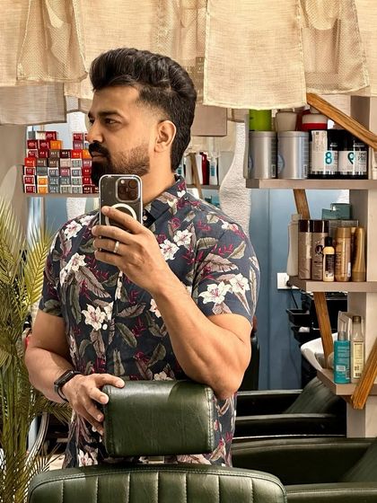 A client selfie showing off his fresh cut. A well-executed fade with texture on top looks great even in a mirror pic.