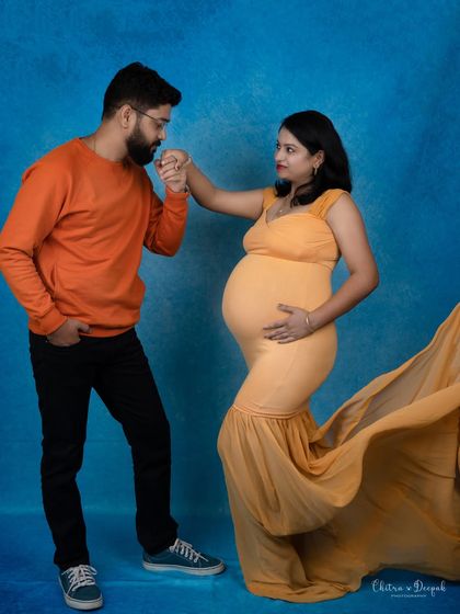 A romantic pose with a flowing yellow gown. The way he kisses her hand adds a touch of classic romance and chivalry.