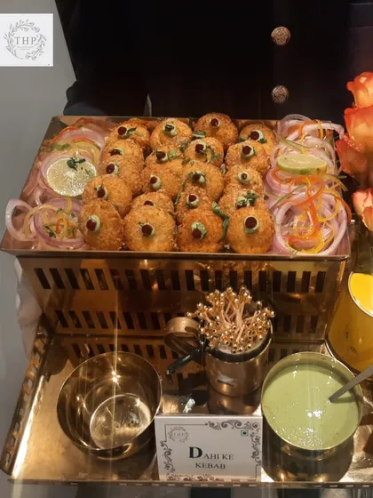Our Dahi ke Kebab is a crowd favourite for a reason. A server presents a tray of perfectly crisp kebabs, garnished and ready to be served with our signature green chutney. It's the perfect start to any celebration.