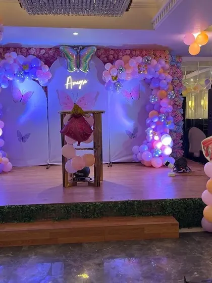 A duplicate of the butterfly and princess themed stage decoration, showing the full setup with purple lighting.